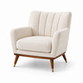 Poltrona in tessuto bouclé beige con gambe in legno e ottone